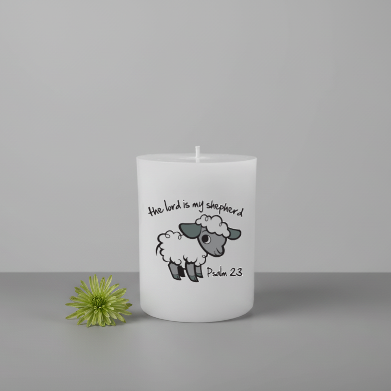 White candle with a sheep illustration and text on a gray background