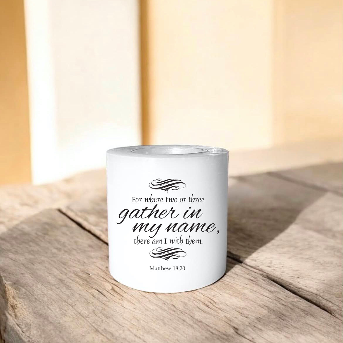 white everlasting candle with text on a wooden surface