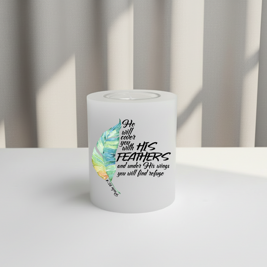 White everlasting candle with feather design and text on a white surface