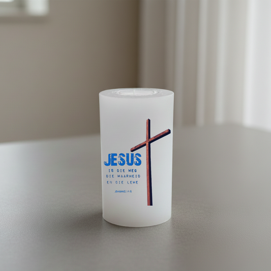 White candle with a cross and text on a neutral background