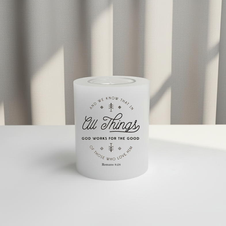 White candle with text on a white surface with striped background