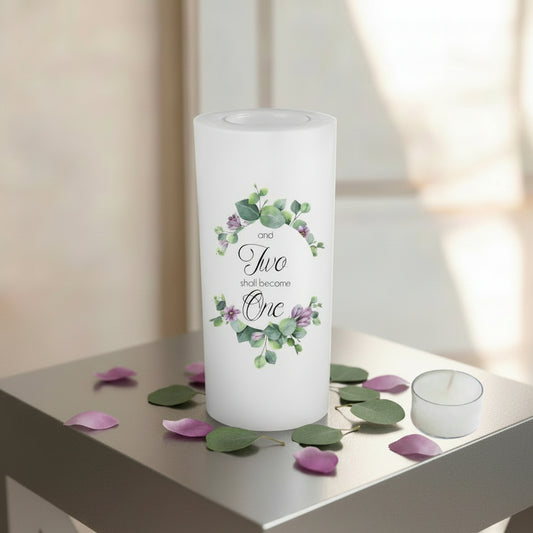 A white candle with a green and purple colours flower design and the union text 