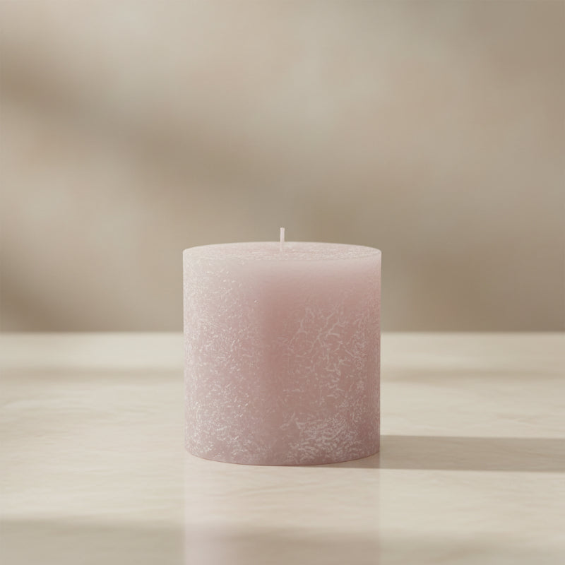 dustypink candle on a  surface