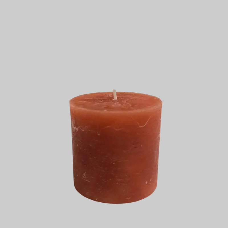 Terracotta candle on a surface with neutral background