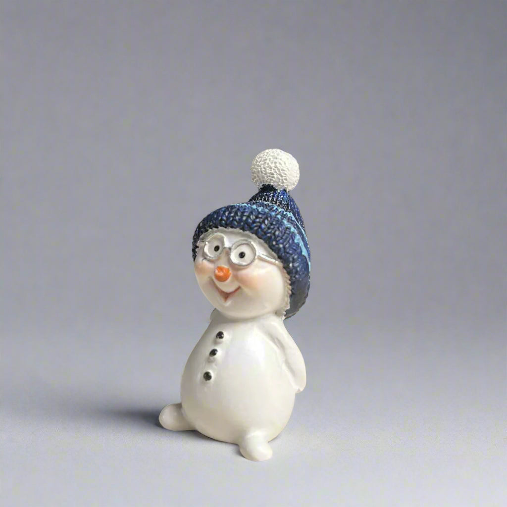 Small snowman figurine with a blue beanie and glasses