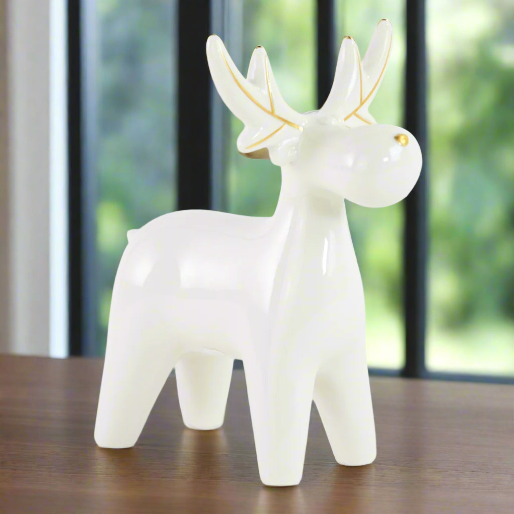 White ceramic elk or moose figurine with gold accents 