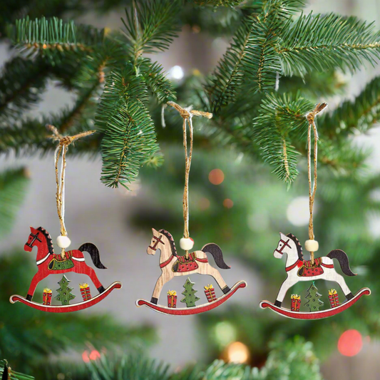 Three wooden rocking horse ornaments with Christmas tree designs