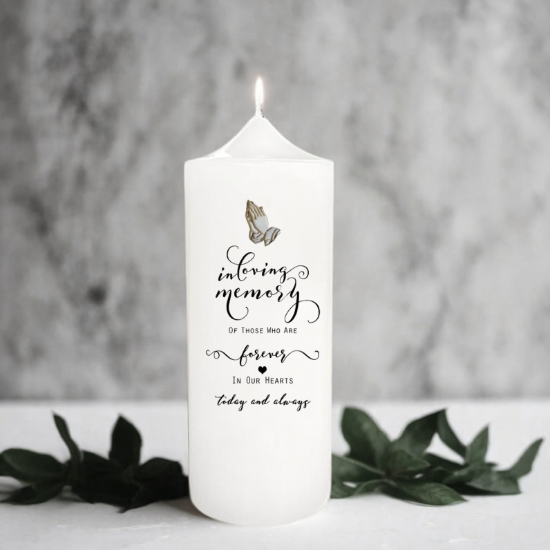 White memory candle with text and butterfly design on a gray background
