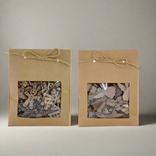 Two brown paper packages with windowed panels containing wooden scatter christmas decoration