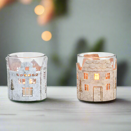 Two glass candle holders with house designs made of felt