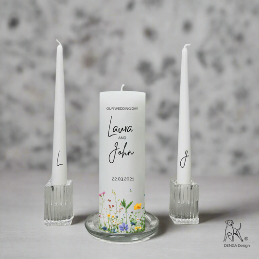 Personalized wedding candle with floral design and two tall candles on a gray background