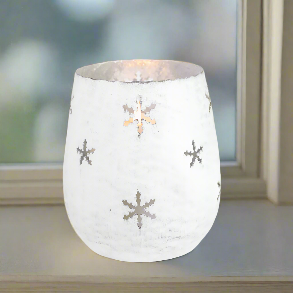White metal candle holder with snowflake patterns