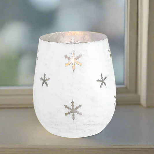 White metal candle holder with snowflake patterns