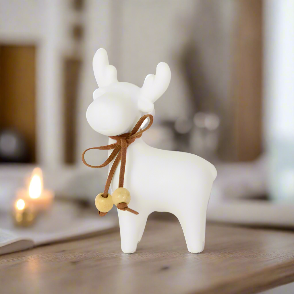 White porcelain deer figurine with a brown ribbon and wooden beads 