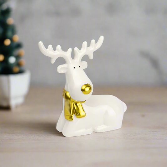 White porcelain reindeer figurine with a gold bell 