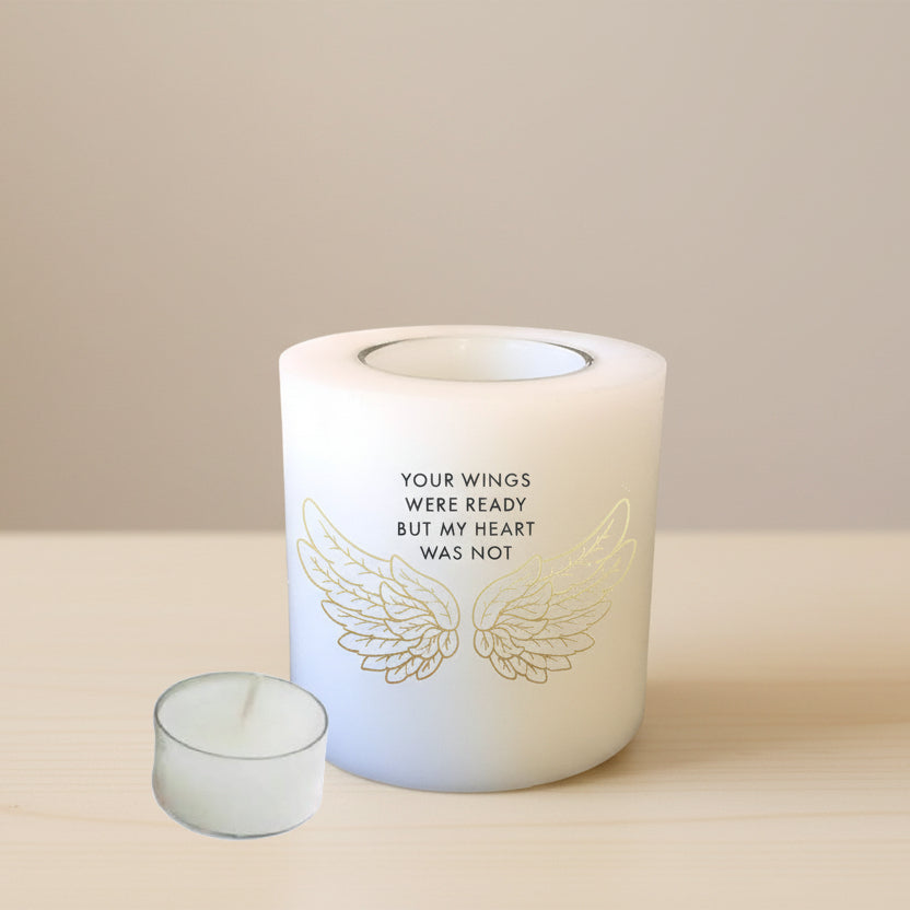 Candle with wings and text on a white background