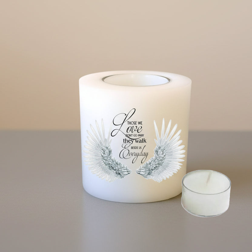Candle with text and wings on a neutral background