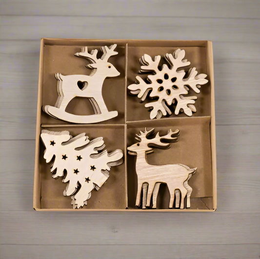 Wooden Christmas ornaments including reindeer and snowflakes in a box on a woodenbackground