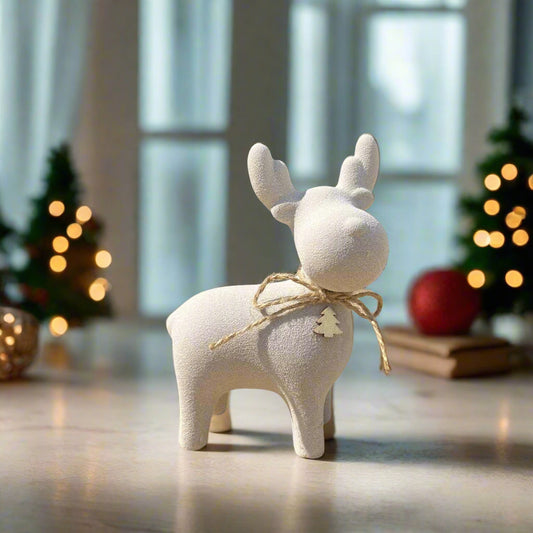 Beige ceramic moose in a festive decorated room