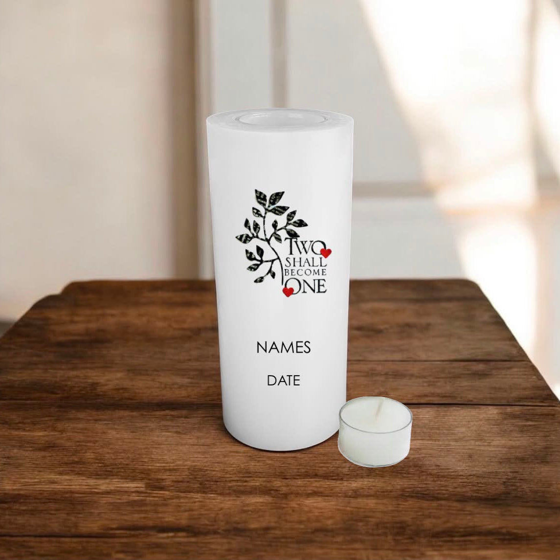 A white printed candle with custom design that features a black leafy tree branch, a small red heart, and the text 'TWO SHALL BECOME ONE' with 'NAMES' and 'DATE' printed below.