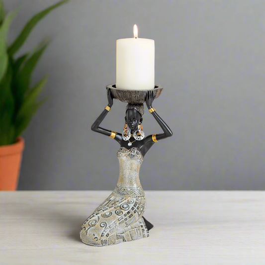 Decorative candle holder shaped like a woman holding a candle on a grey background