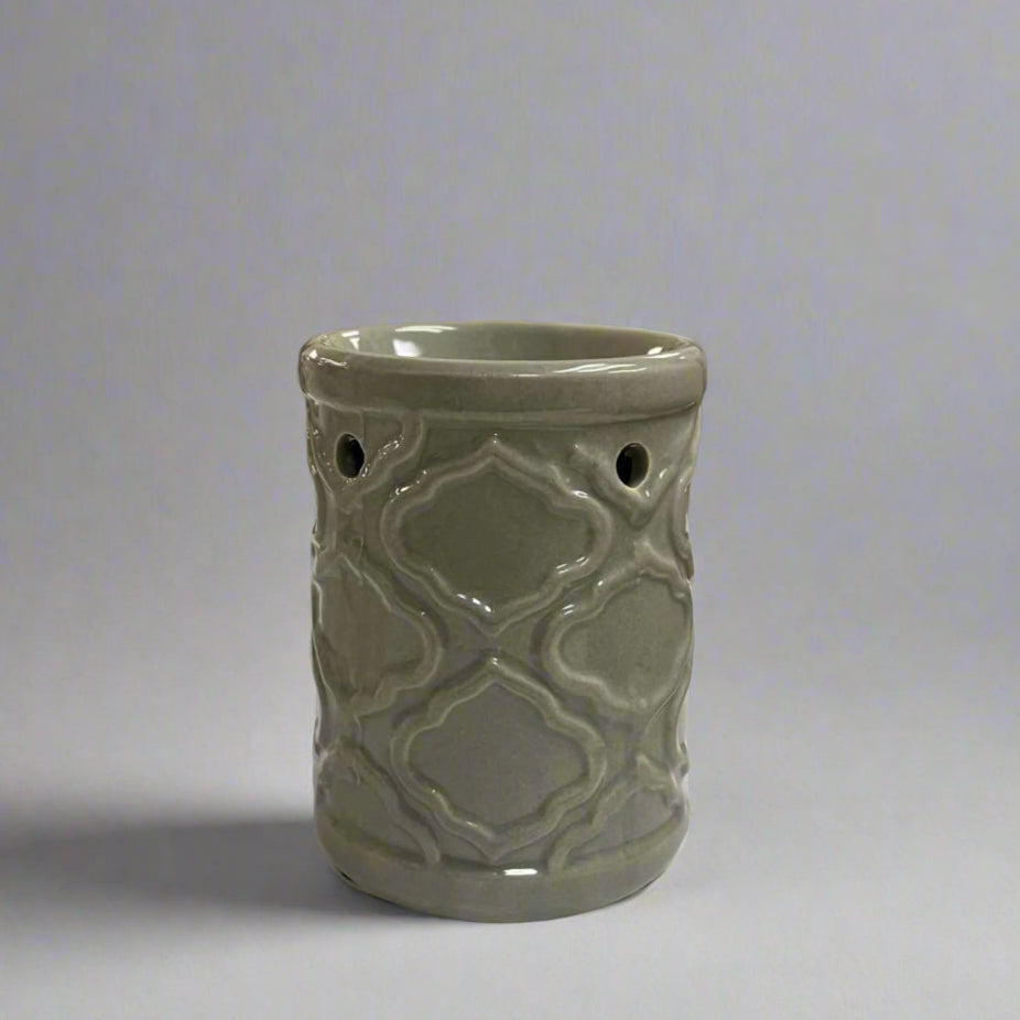 Decorative ceramic burner with geometric pattern on a neutral background