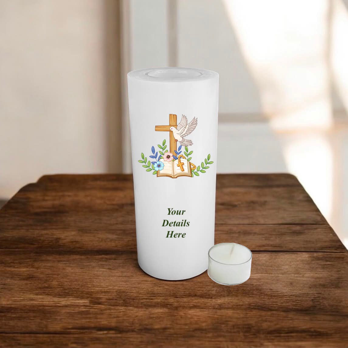 White candle with religious design on a wooden surface