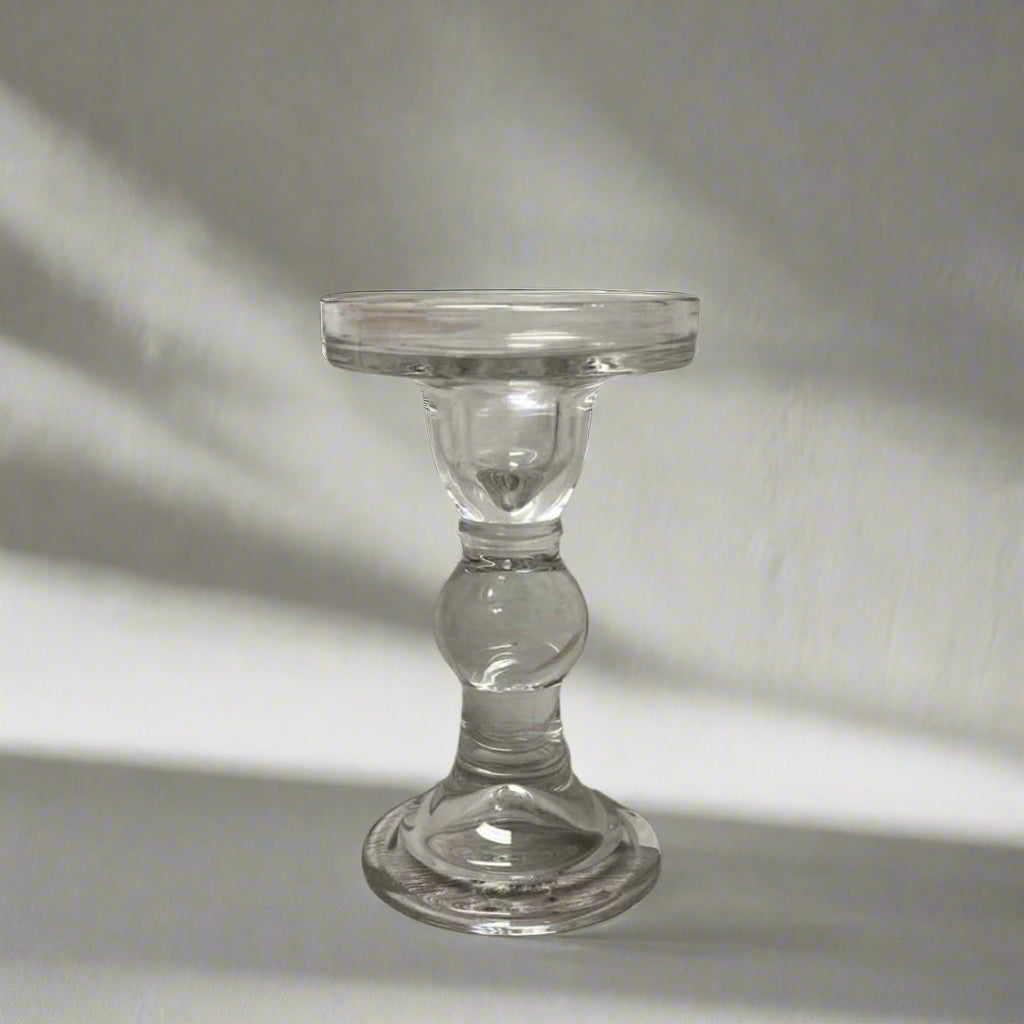 Clear glass candle holder on a wooden surface 