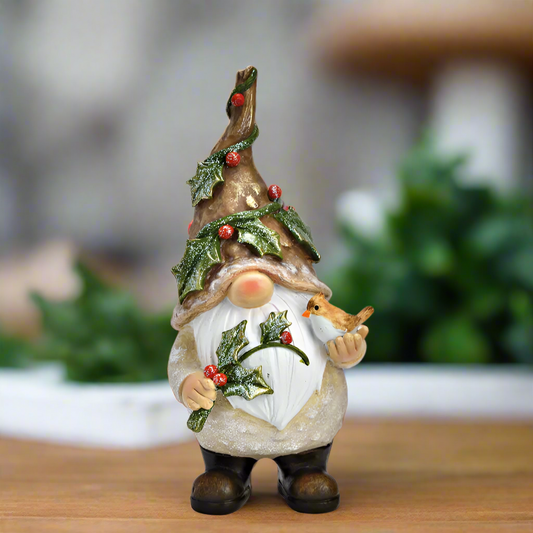 Decorative gnome figure with a festive hat and holly decorations with a bird