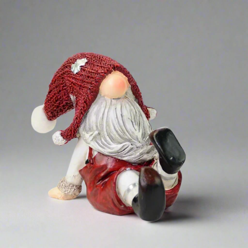 Decorative gnome figurine with a red hat and outfit on a white background