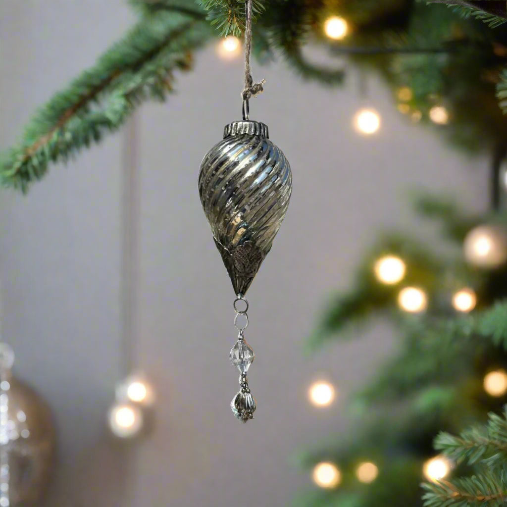 hanging silver glass ornament on a Christmas tree