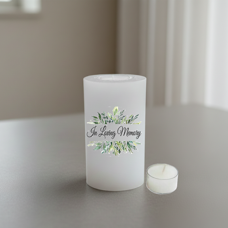 A white candle with the words 'In Loving Memory' and a green watercolor floral design.