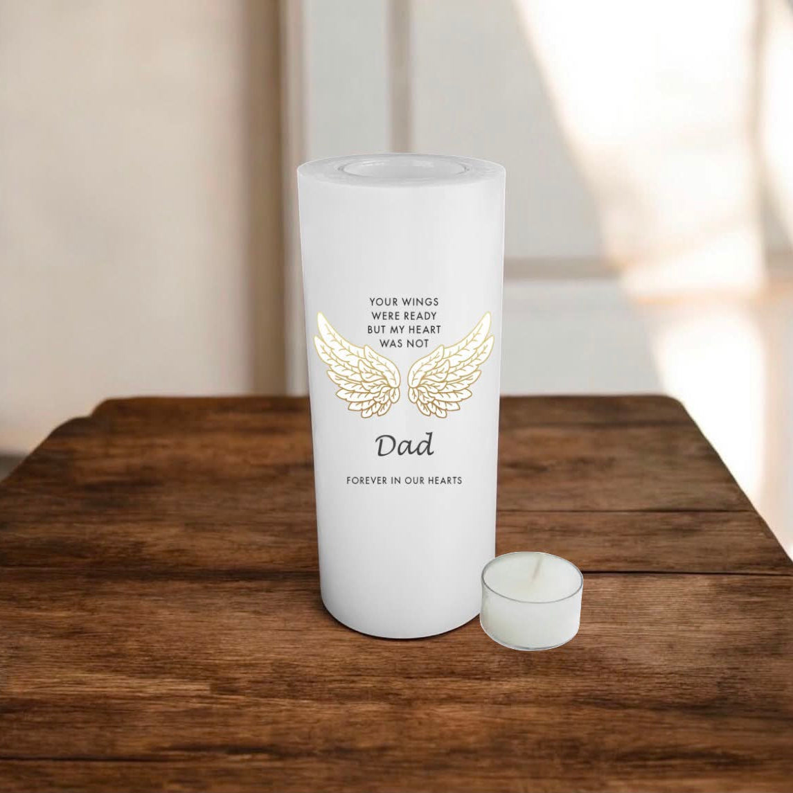white candle with a text about Dad, placed on a wooden surface
