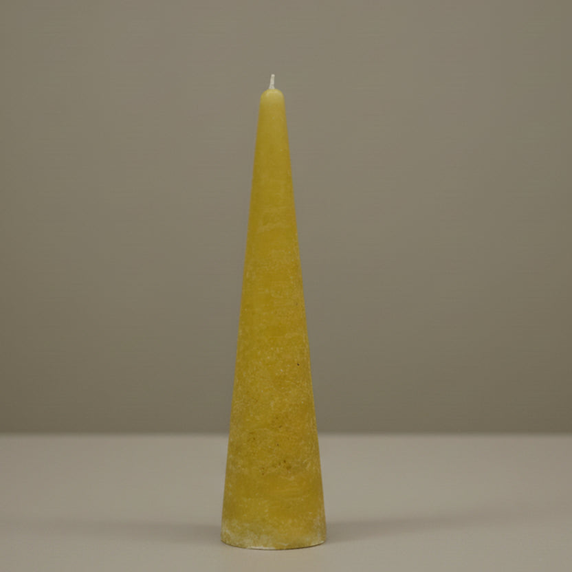 mustard cone-shaped candle on a surface 