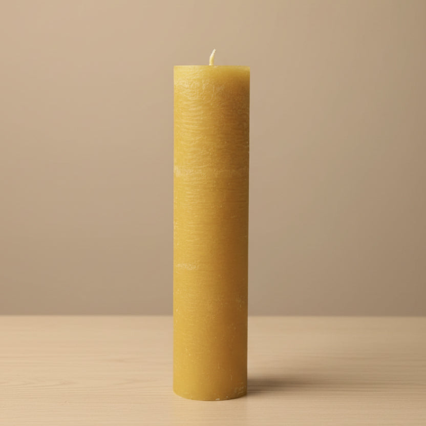 mustard candle on a table and a neutral background