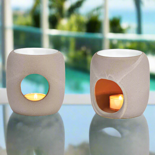 two-scent-burner-ceramic-on a glass table in front of a window