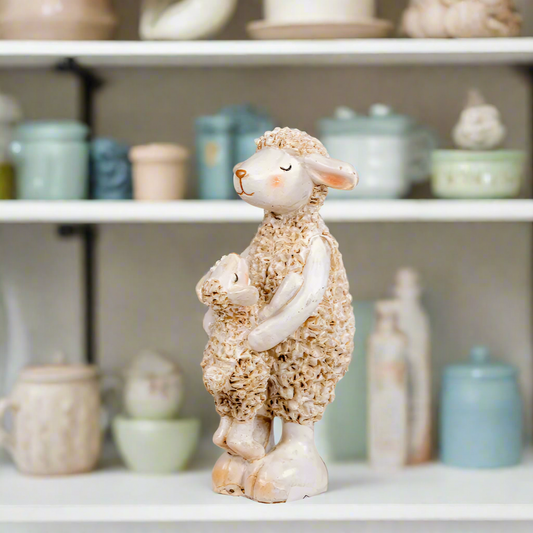 Decorative sheep figurine holding a baby lamb 