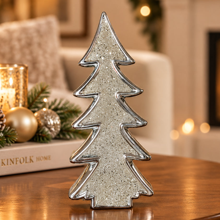 A silver glitter Christmas tree-shaped ceramic ornament, shown on a plain white background.