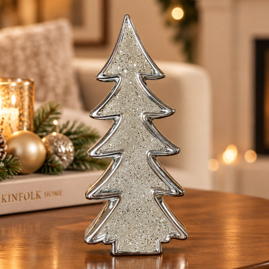 A silver glitter Christmas tree-shaped ceramic ornament, shown on a plain white background.