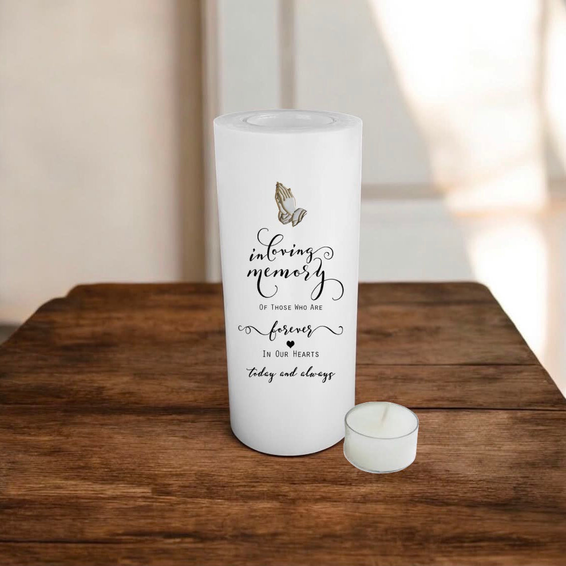 white candle on a wooden surface with a print
