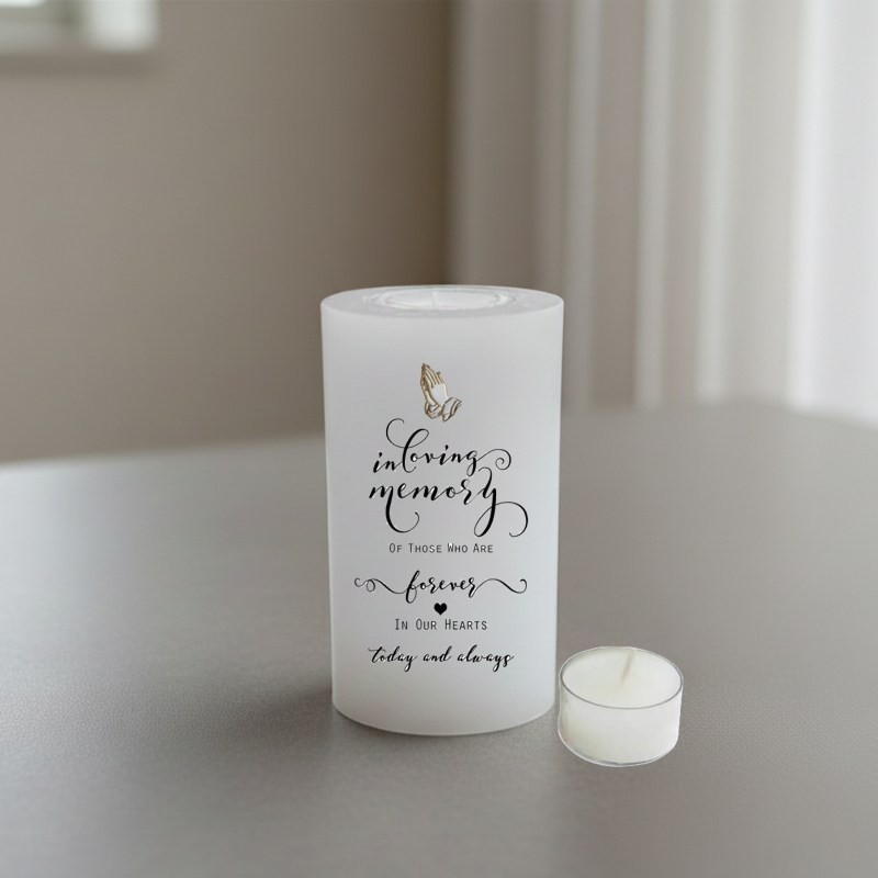 white candle with print on a grey surface