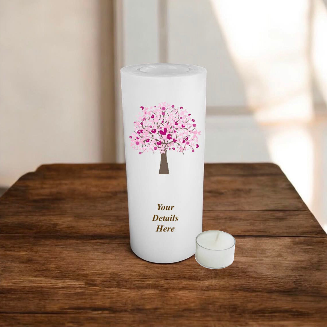 Personalised candle with a pink tree design on a wooden surface