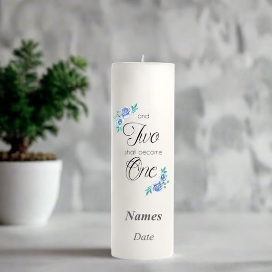 Wedding white candle with decorative text and floral designs on a blurred background