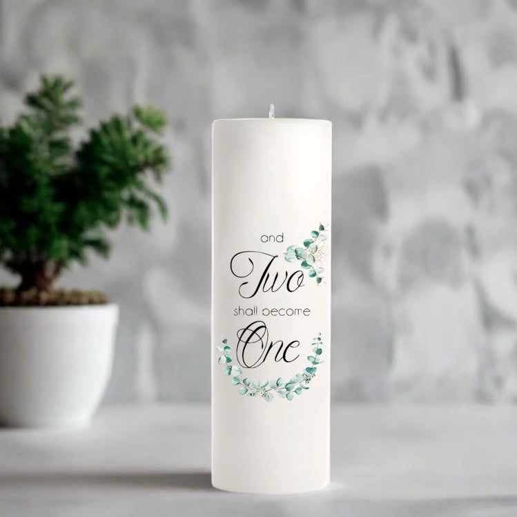 White wedding candle with decorative text and floral design on a neutral background