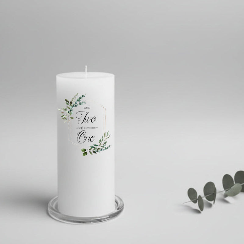 White wedding candle with greenery design and text on a gray background