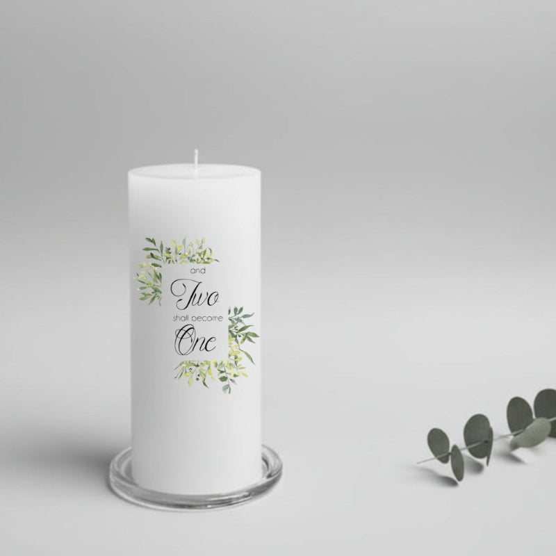 White wedding candle with greenery design and text on a grey background