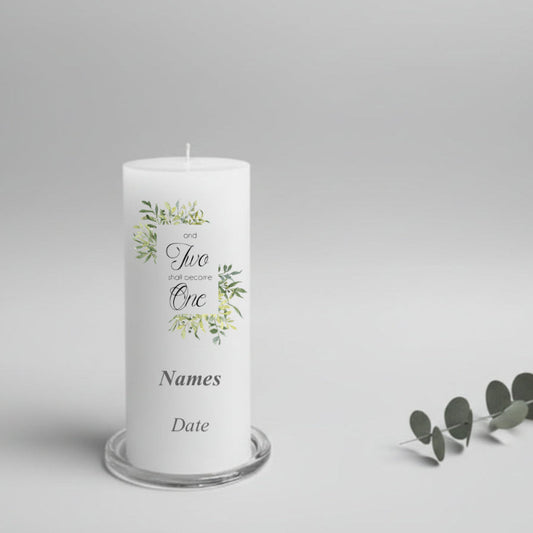 White wedding candle with greenery design and text on a gray background