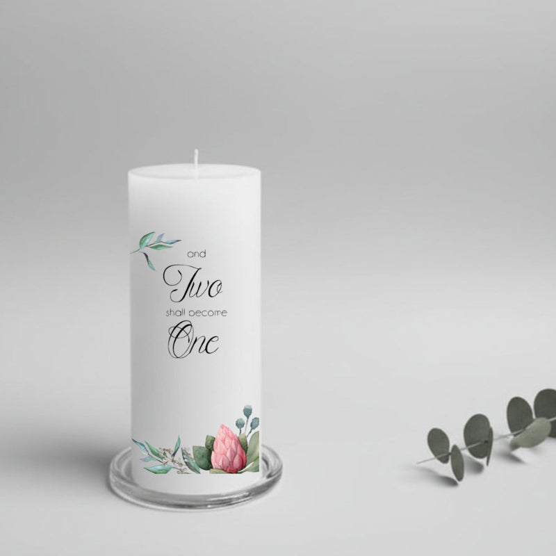 White wedding candle with floral design and text on a gray background