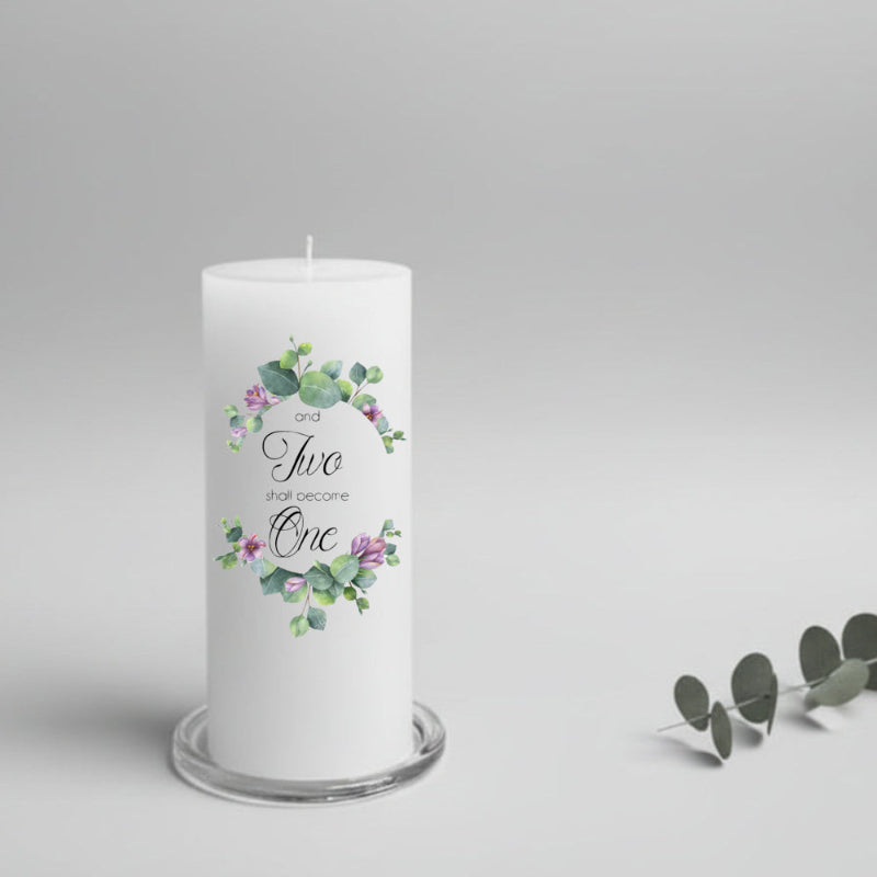 White wedding candle with floral design and text on a gray background