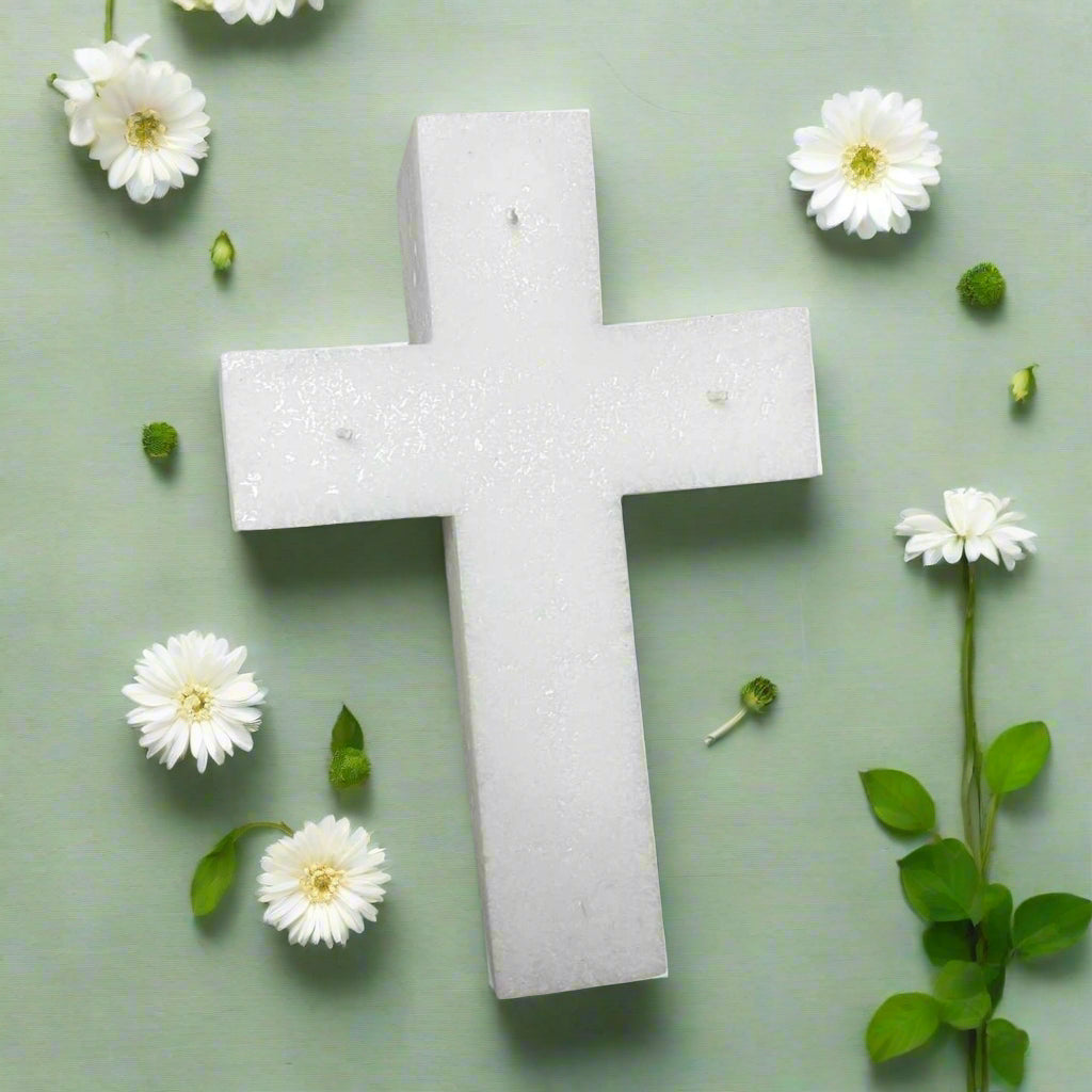 White cross-shaped candle with 3 wicks